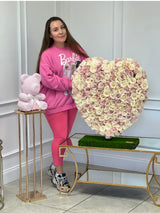 woman holding heart made of roses