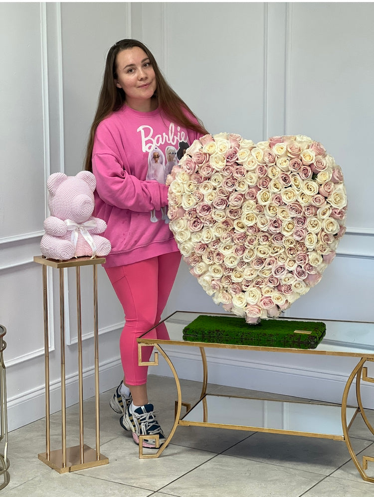 woman holding heart made of roses