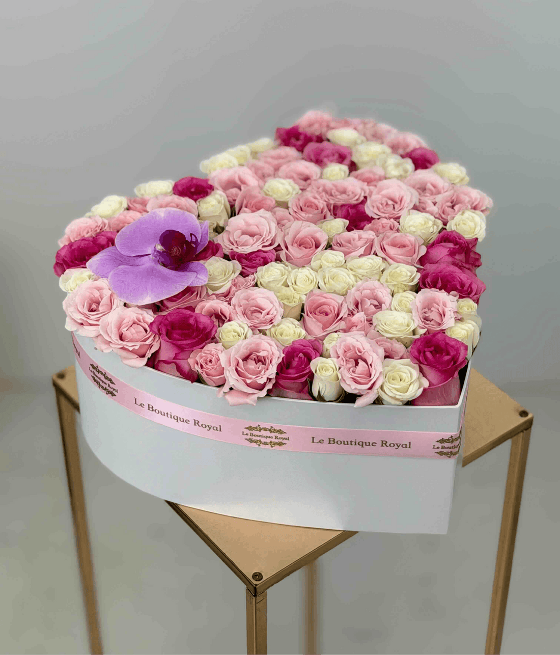 Luxury heart-shaped flower box with pink and white roses and a purple orchid by Le Boutique Royal in Miami.
