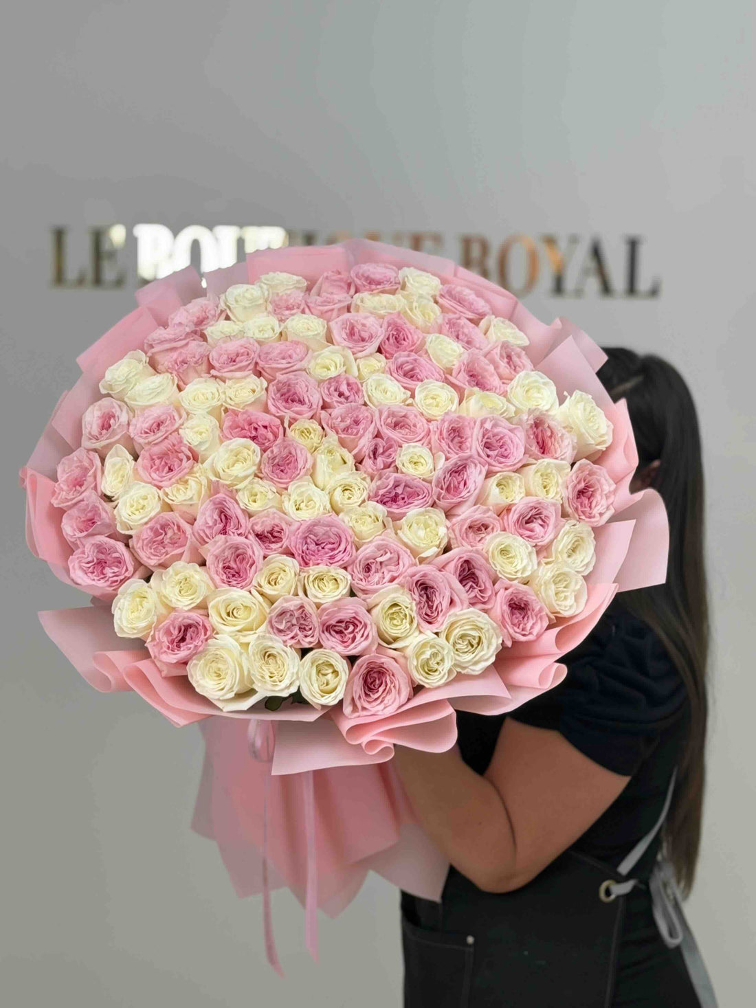 Luxury bouquet of blush pink and ivory garden roses wrapped in elegant pink paper, handcrafted by Le Boutique Royal.