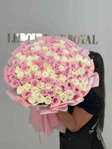 Luxury bouquet of blush pink and ivory garden roses wrapped in elegant pink paper, handcrafted by Le Boutique Royal.