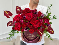 
                    
                      a person holding red flowers
                    
                  