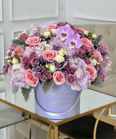 
                    
                      Arreglo floral mixto de flores de color púrpura en un jarrón de lavanda
                    
                  