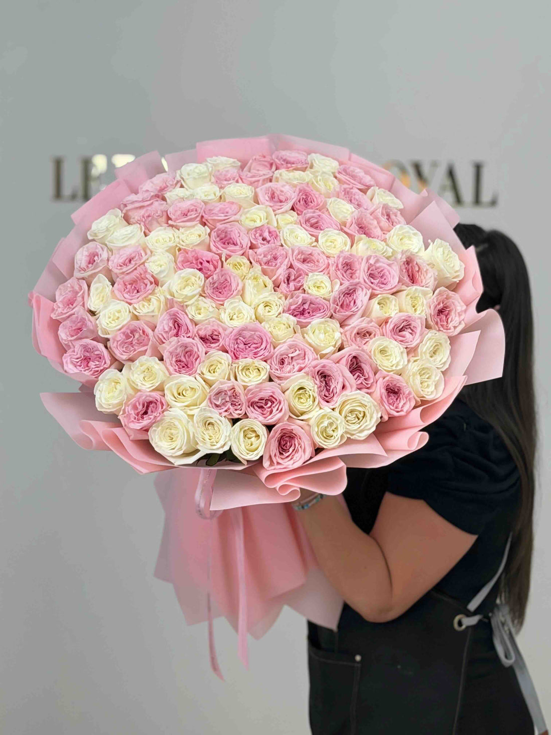 Luxury bouquet of blush pink and ivory garden roses wrapped in elegant pink paper, handcrafted by Le Boutique Royal.