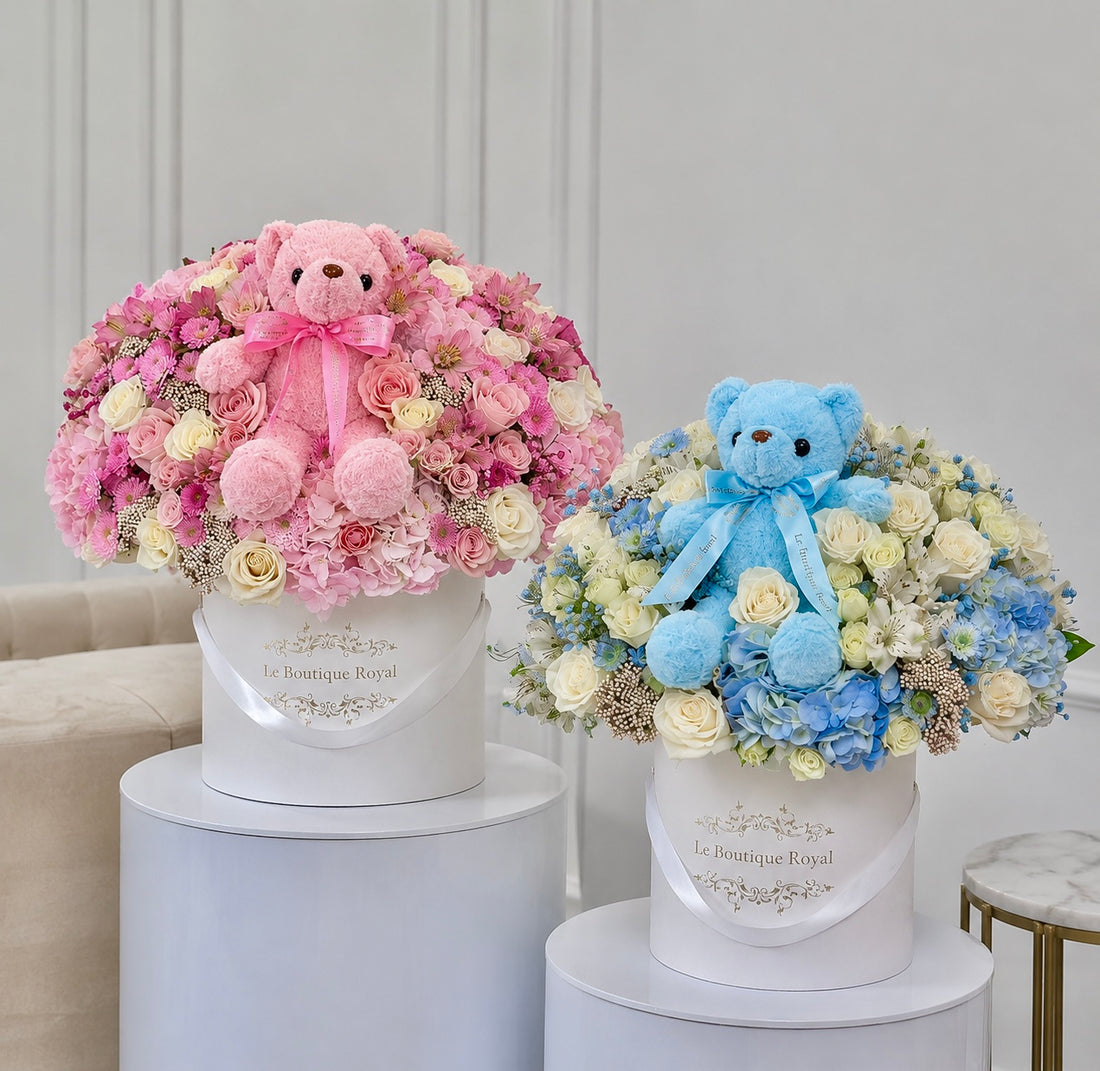 Pink and blue baby flower arrangements with teddy bears by Le Boutique Royal, perfect for new baby gifts and gender reveal celebrations.
